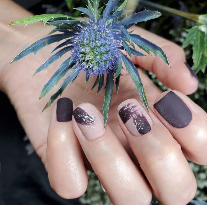Dark minimalist matte nail art with negative space